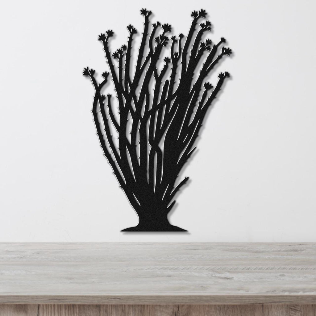 Black metal ocotillo wall art with branching stems and flower cutouts, mounted on a white wall above a wooden counter.
