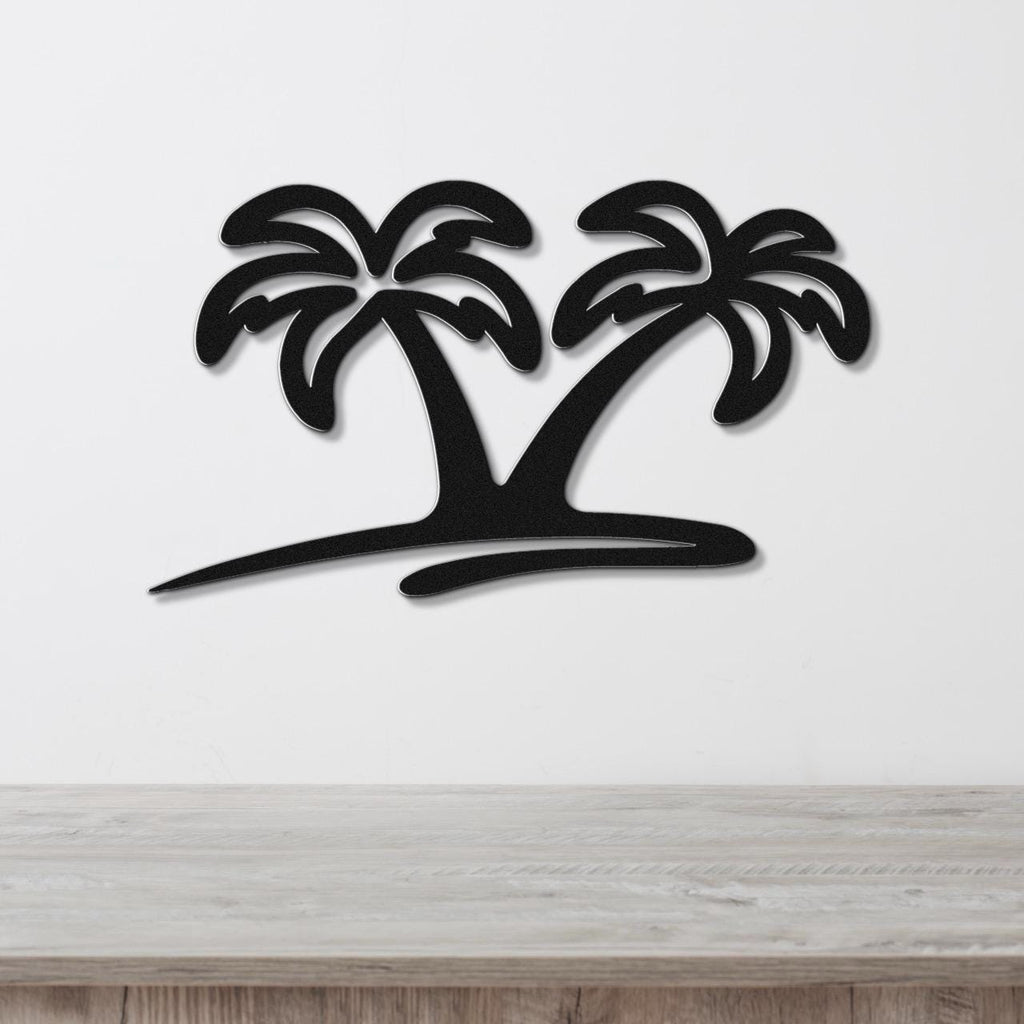 Black metal wall art featuring a silhouette of two palm trees with cutout fronds, mounted on a white wall above a wooden surface.