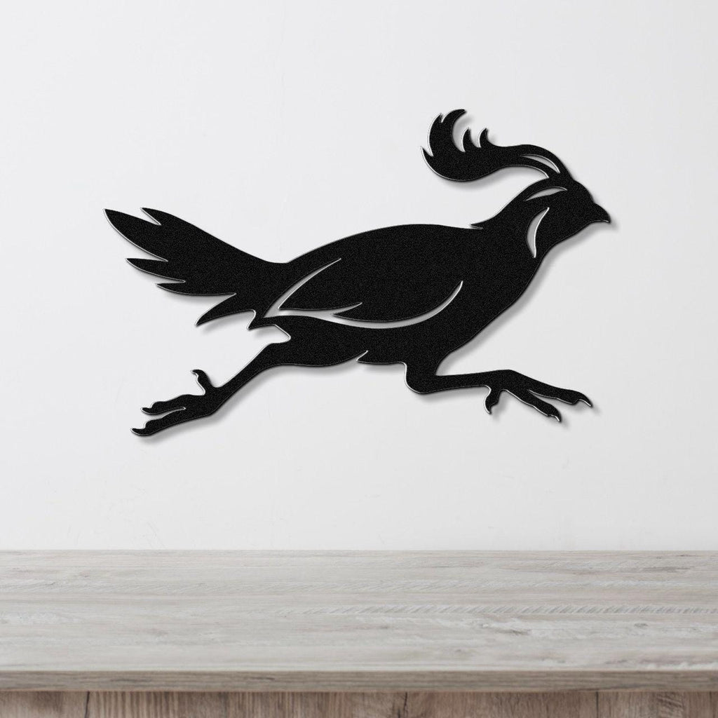 Black metal quail wall art in a running silhouette, mounted on a white wall above a light wood counter.