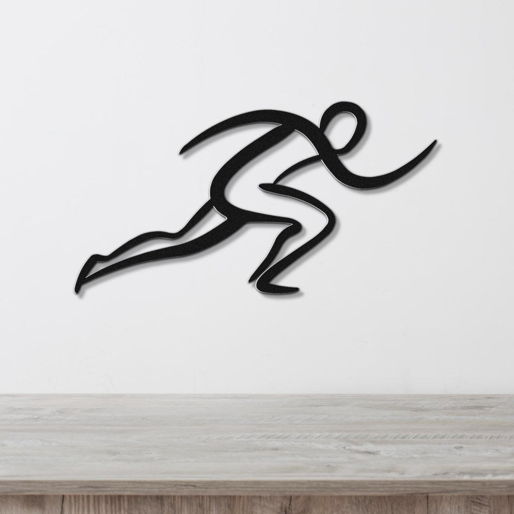 Black metal runner wall art with dynamic motion-line cutouts, mounted on a white wall above a light wood countertop.