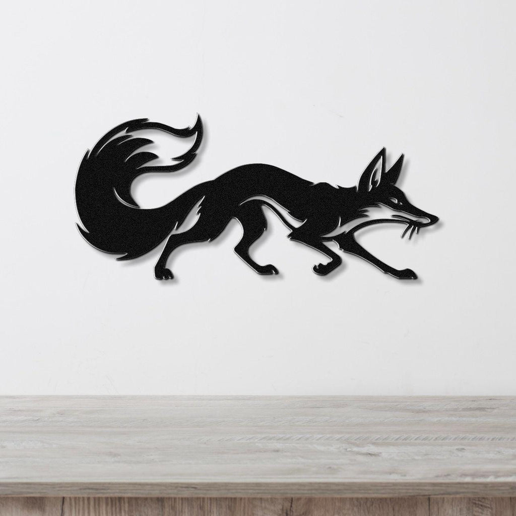 Black metal fox wall art in a running silhouette with a curled tail, mounted on a white wall above a light wood countertop.