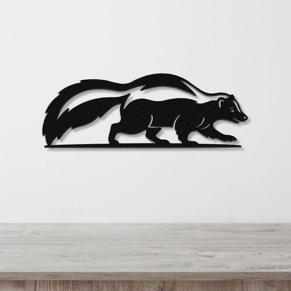 Black metal skunk wall art silhouette with motion-line cutouts, mounted on a white wall above a light wood counter.