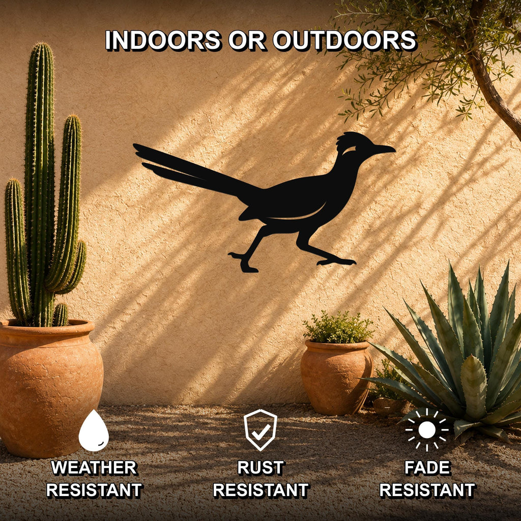 Black metal roadrunner wall sculpture with long tail and running pose, mounted on a stucco outdoor wall among potted cacti and succulents.