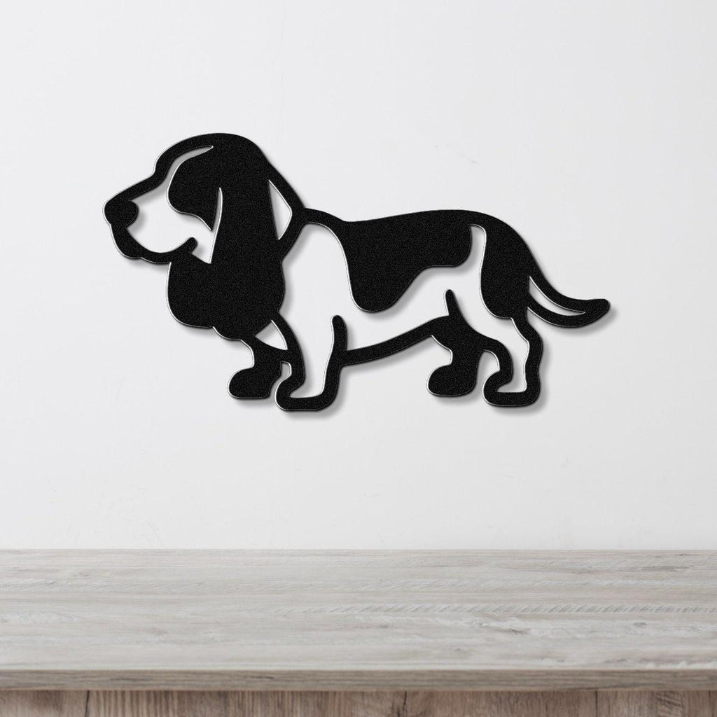 Black metal Basset Hound wall art silhouette with cutout details, mounted on a white wall above a light wood counter.