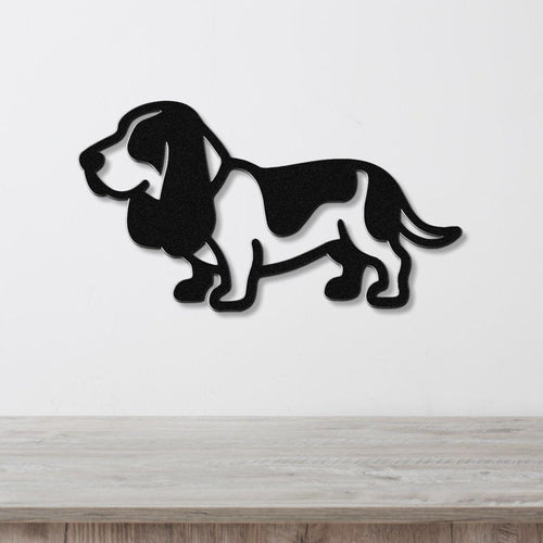 Black metal Basset Hound wall art silhouette with cutout details, mounted on a white wall above a light wood counter.