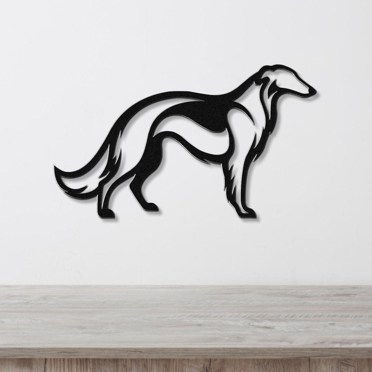 Black metal Borzoi dog wall art with a sleek silhouette design, mounted on a white wall above a light wood surface.