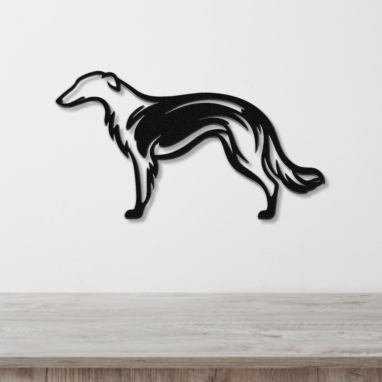 Black metal wall art of a Borzoi dog in a graceful silhouette with internal motion-line cutouts, mounted on a white wall above a light wood counter.