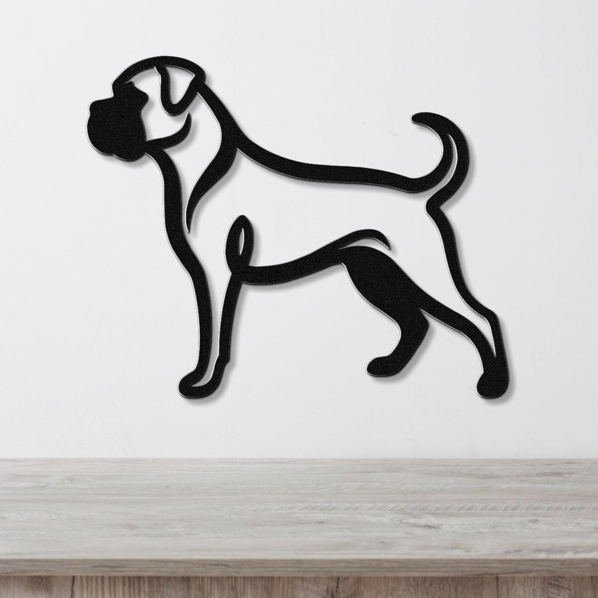 Black metal Boxer dog wall art in a bold silhouette style, mounted on a white wall above a light wood surface.
