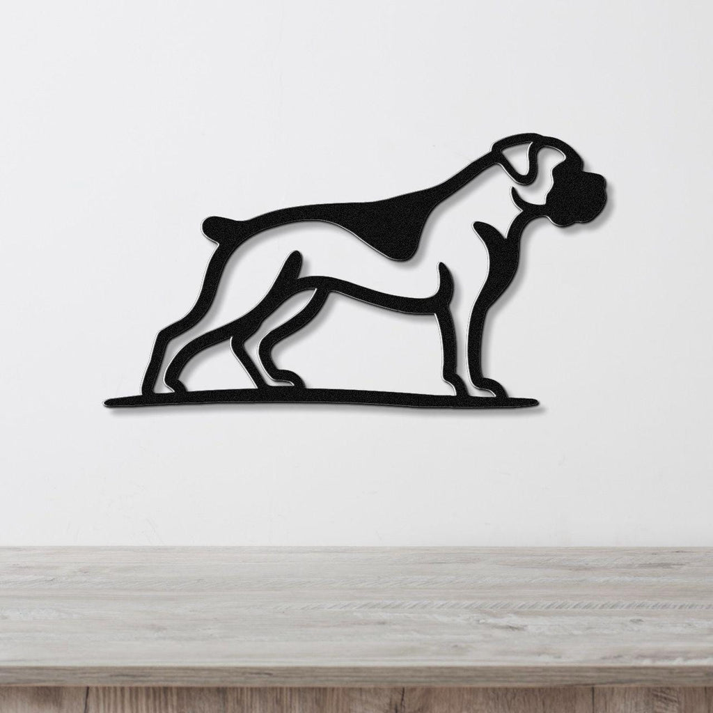 Black metal wall art silhouette of a boxer dog in profile, mounted on a white wall above a light wood surface.
