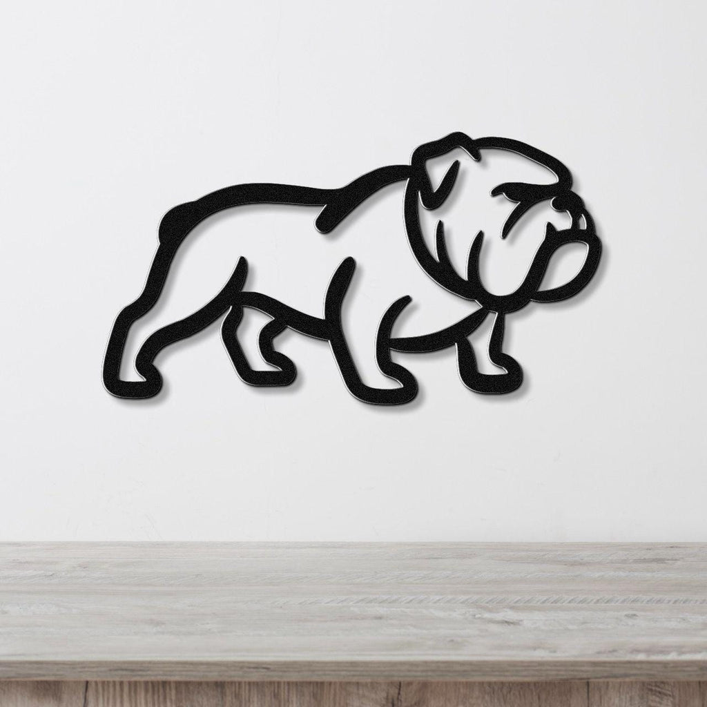 Black metal bulldog wall art with a bold silhouette and internal cutout details, mounted on a white wall above a light wood counter.