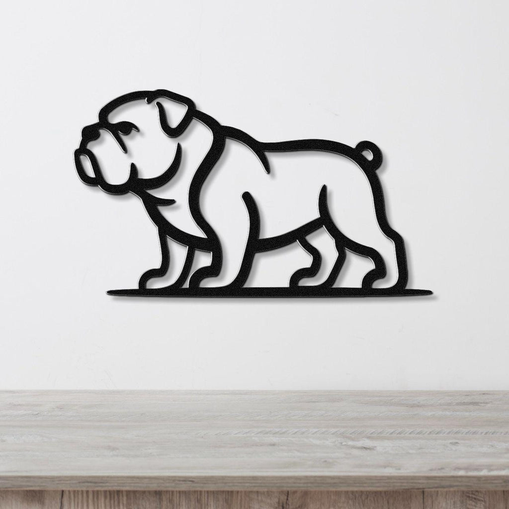 Black metal bulldog wall art with a minimalist silhouette design, mounted on a white wall above a light wood surface.