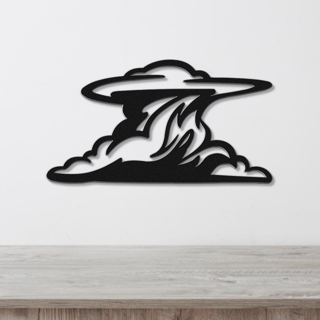 Black metal wall art in a cloud silhouette with internal flame-like cutouts, mounted on a white wall above a light wood surface.
