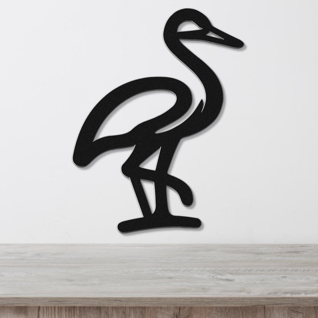 Black metal crane wall art with a minimalist silhouette design, mounted on a white wall above a light wood surface.