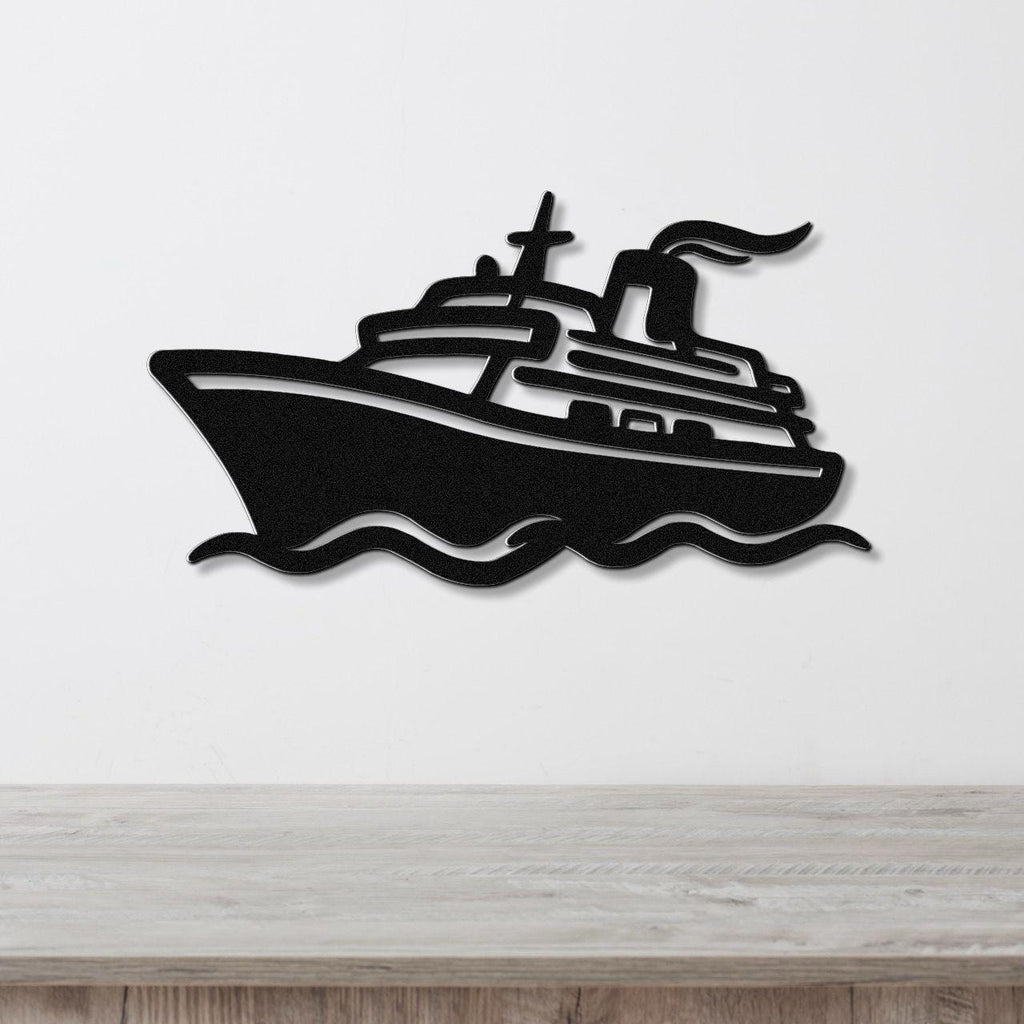 Black metal wall art cutout of a cruise ship with wavy water lines, mounted on a white wall above a light wood counter.