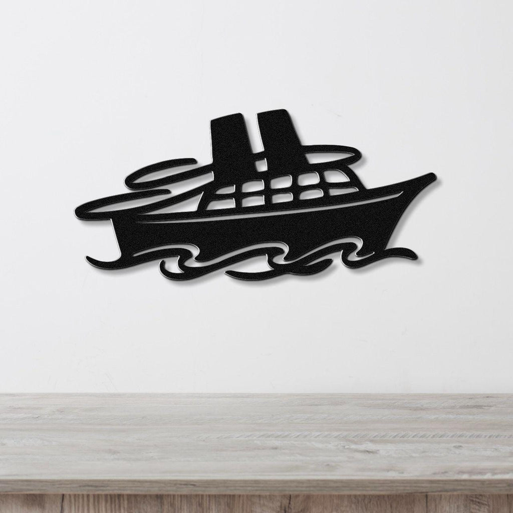 Black metal wall art cutout of a cruise ship with smokestacks and window details, mounted on a white wall above a light wood counter.