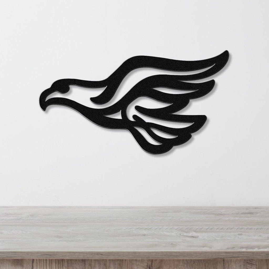 Black metal eagle wall art with wing and head silhouette, mounted on a white wall above a light wood counter.