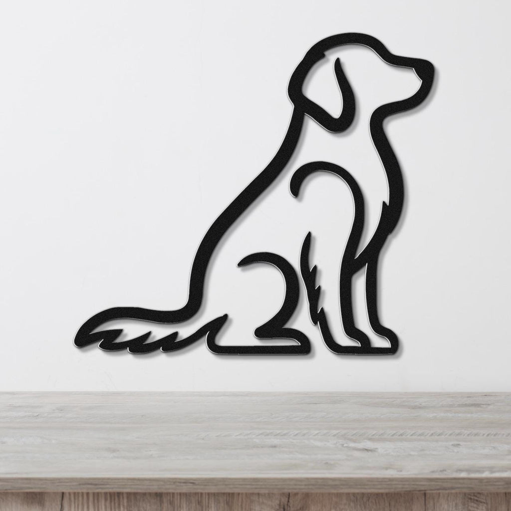Black metal wall art in the silhouette of a sitting dog, mounted on a white wall above a light wood surface.
