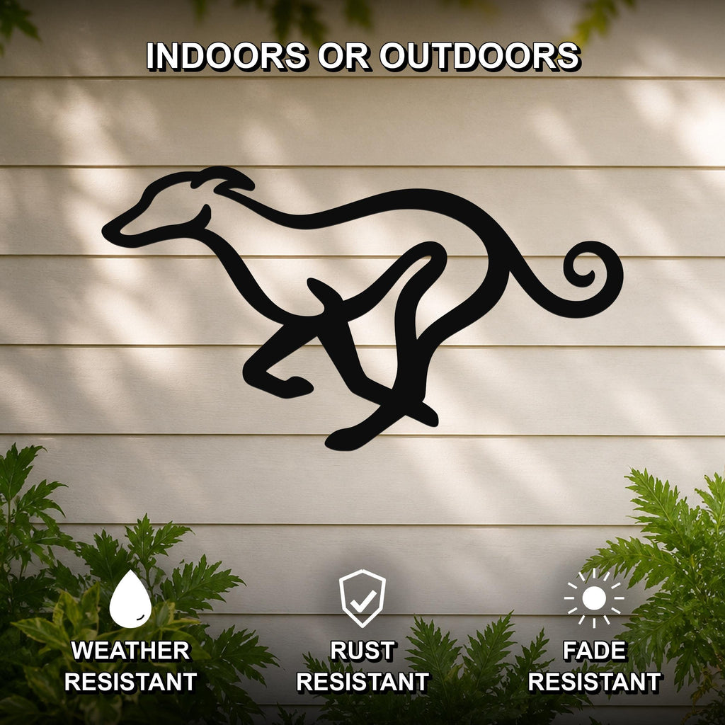 Black metal greyhound wall art in a running silhouette, mounted on a light-colored outdoor wall with greenery, weather resistant, rust resistant, and fade resistant.
