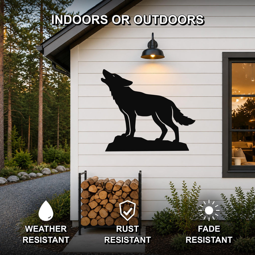 Black metal coyote wall art in a howling silhouette, mounted on a white exterior wall above a firewood rack, with text indicating it is weather, rust, and fade resistant for indoor or outdoor use.