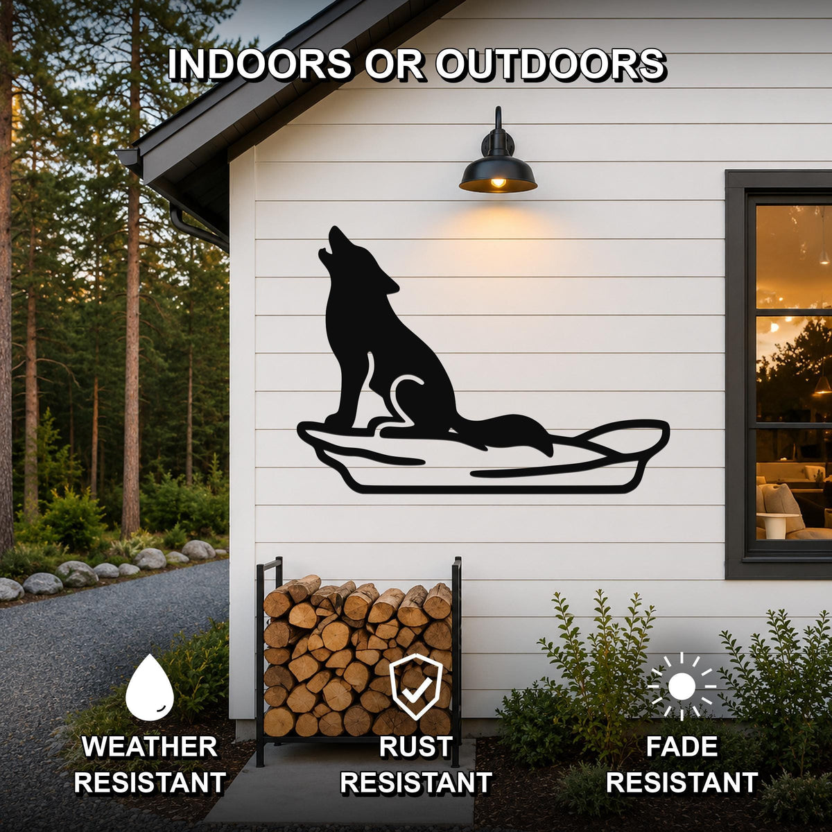 Black metal coyote wall art in a howling silhouette, mounted on a white exterior wall above a firewood rack, with text indicating indoor or outdoor use and weather, rust, and fade resistance.