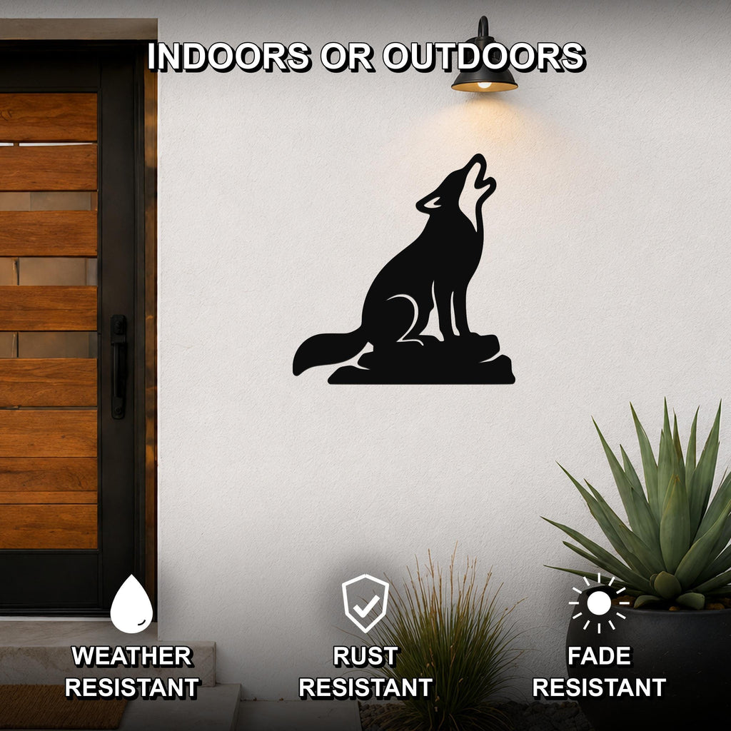 Black metal coyote wall art in a howling silhouette, mounted on an outdoor wall beside a wooden door and potted plants.