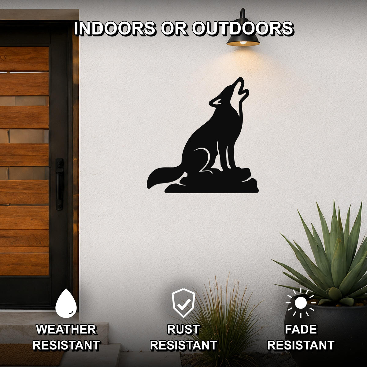 Black metal coyote wall art in a howling silhouette, mounted on an outdoor wall beside a wooden door and potted plants.
