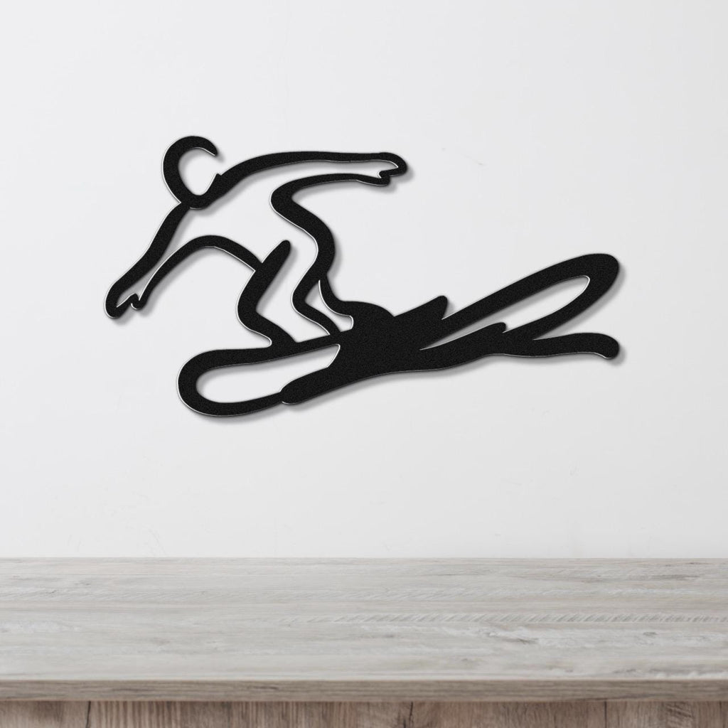 Black metal wall art silhouette of a snowboarder in motion, mounted on a white wall above a light wood counter.