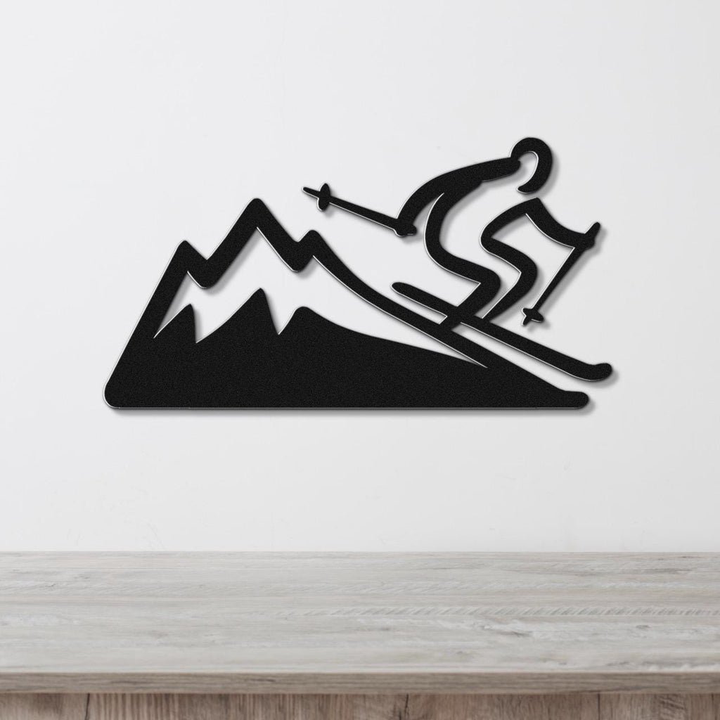 Black metal wall sculpture of a skier descending a mountain, mounted on a white wall above a wooden surface.