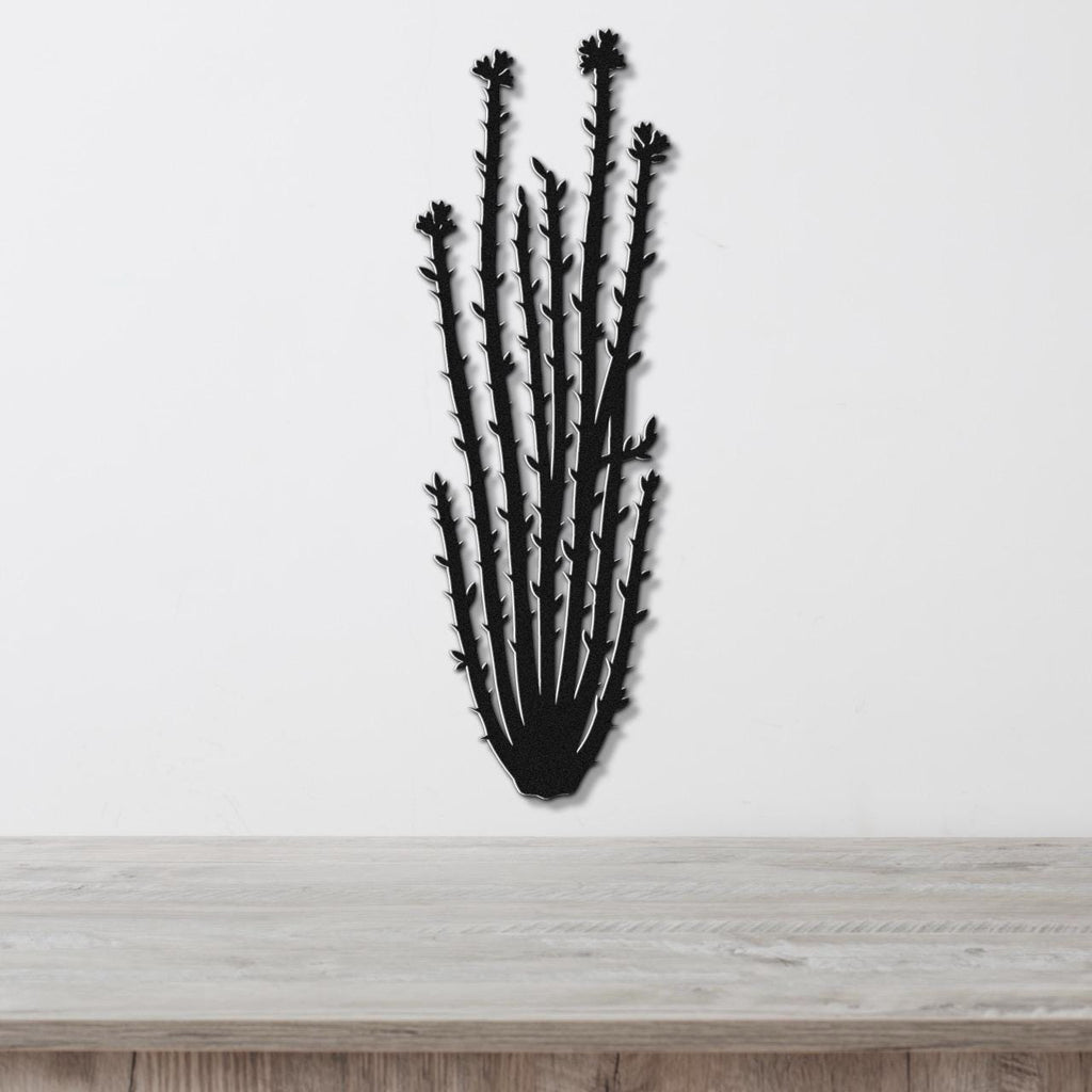 Black metal ocotillo wall art with spiny branches and flower cutouts, mounted on a white wall above a light wood counter.