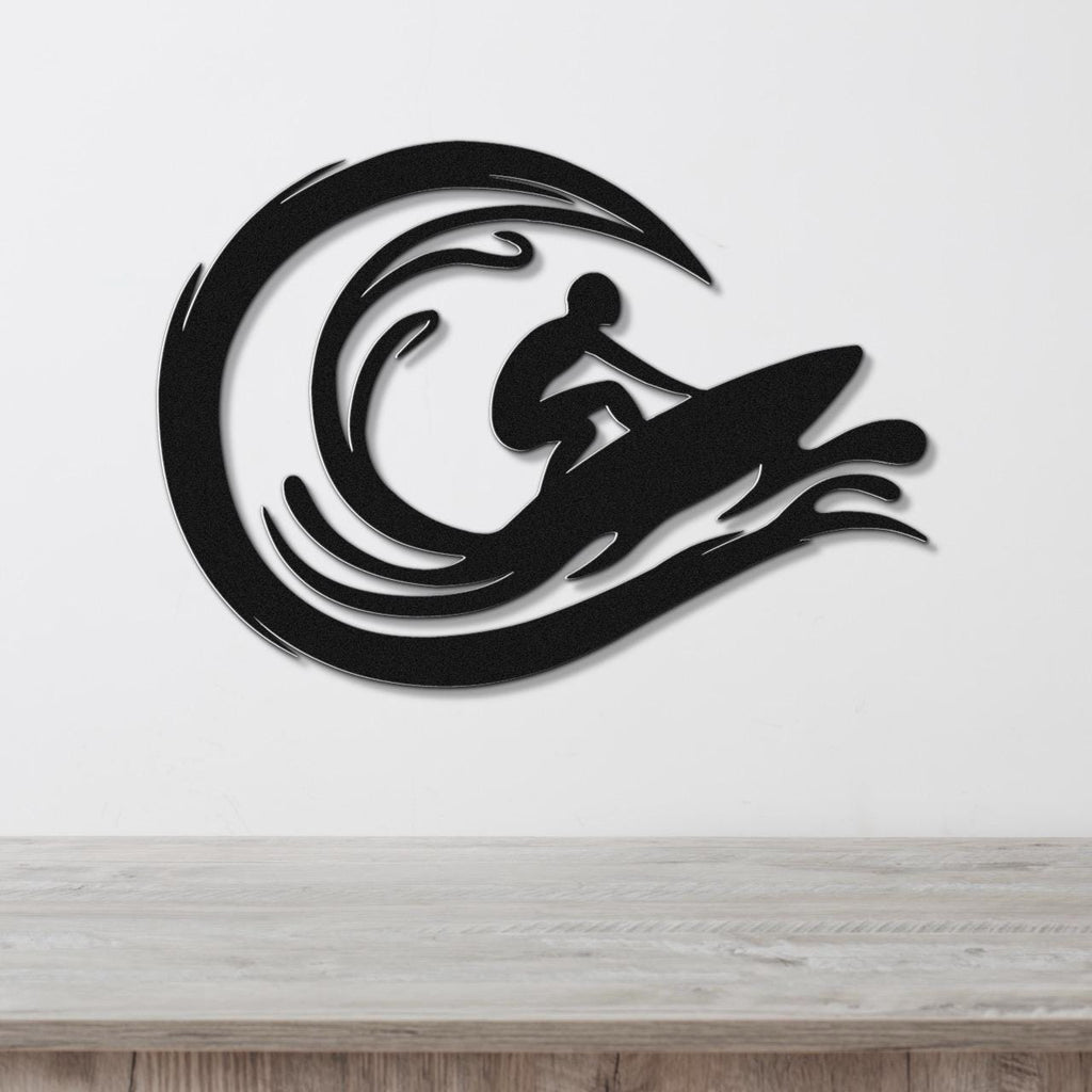Black metal wall art featuring a surfer silhouette riding a wave, mounted on a white wall above a wooden surface.