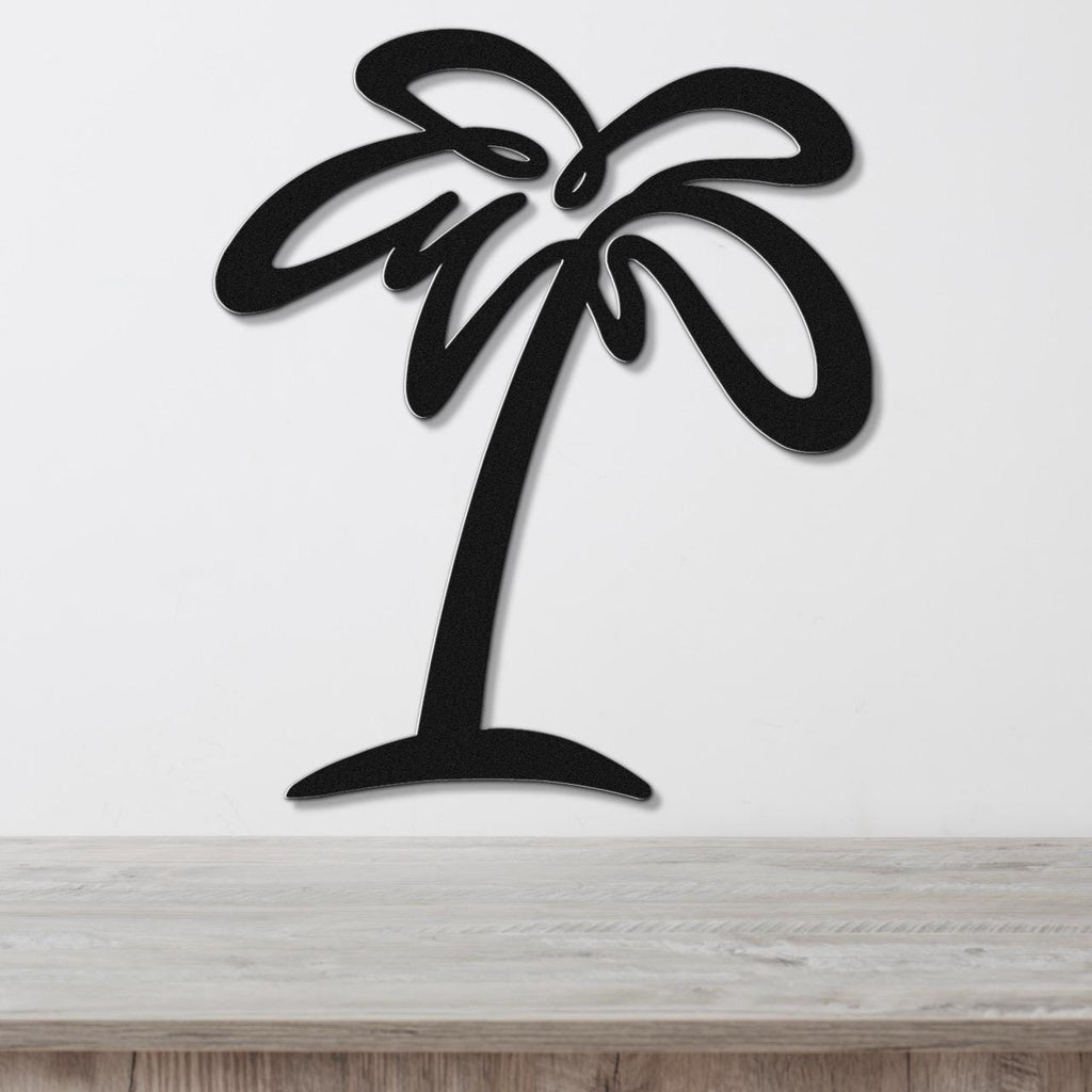 Black metal palm tree wall art with flowing frond cutouts, mounted on a white wall above a light wood countertop.