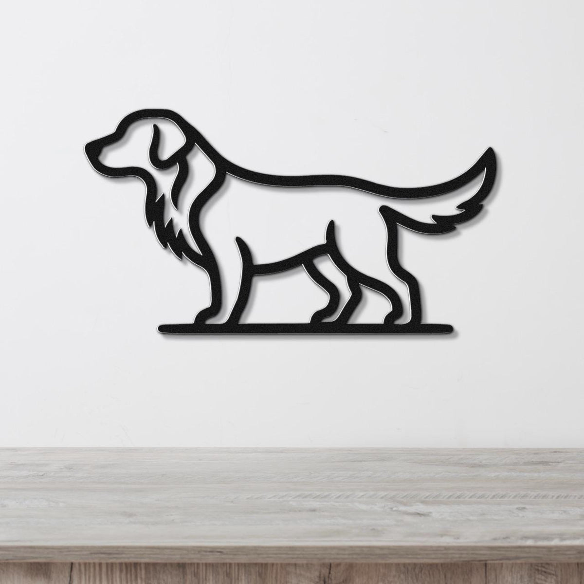 Black metal wall art featuring a retriever silhouette with a long tail and floppy ears, mounted on a white wall above a light wood surface.