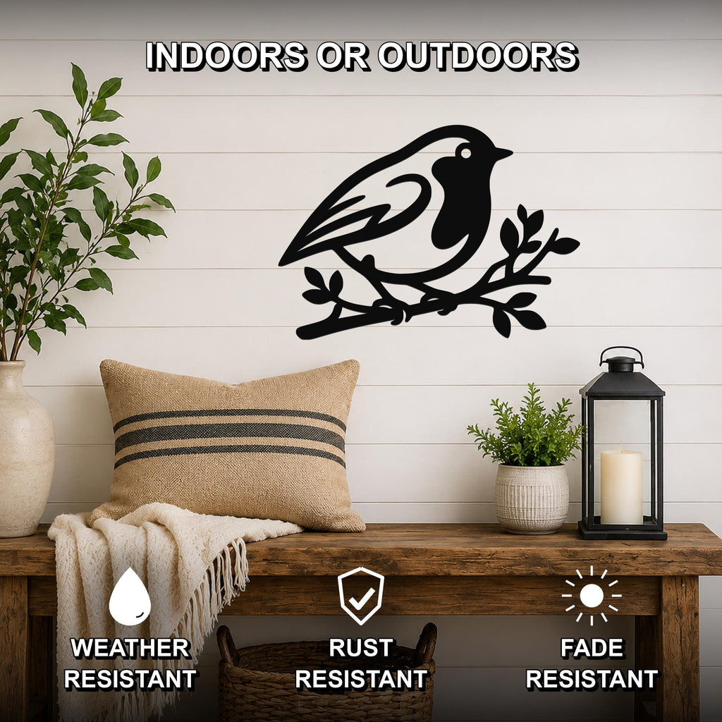Black metal robin wall art silhouette perched on a branch, mounted on a white shiplap wall above a wooden bench in a living room.