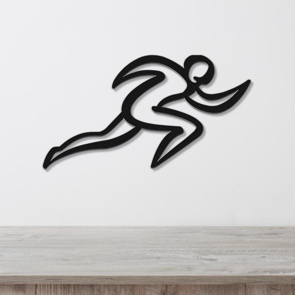 Black metal runner wall art with motion-line cutouts, mounted on a white wall above a wooden counter.