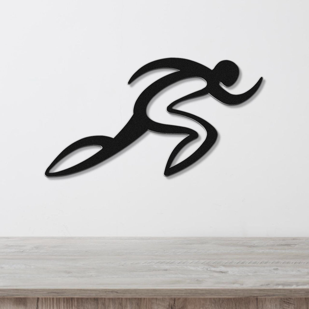 Black metal runner wall art with motion-line cutouts, mounted on a white wall above a light wood surface.