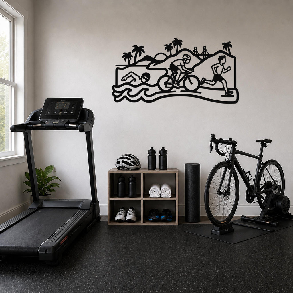 Black metal wall art depicting a triathlon scene with swim, bike, and run silhouettes, mounted on a wall above a storage shelf in a home gym.