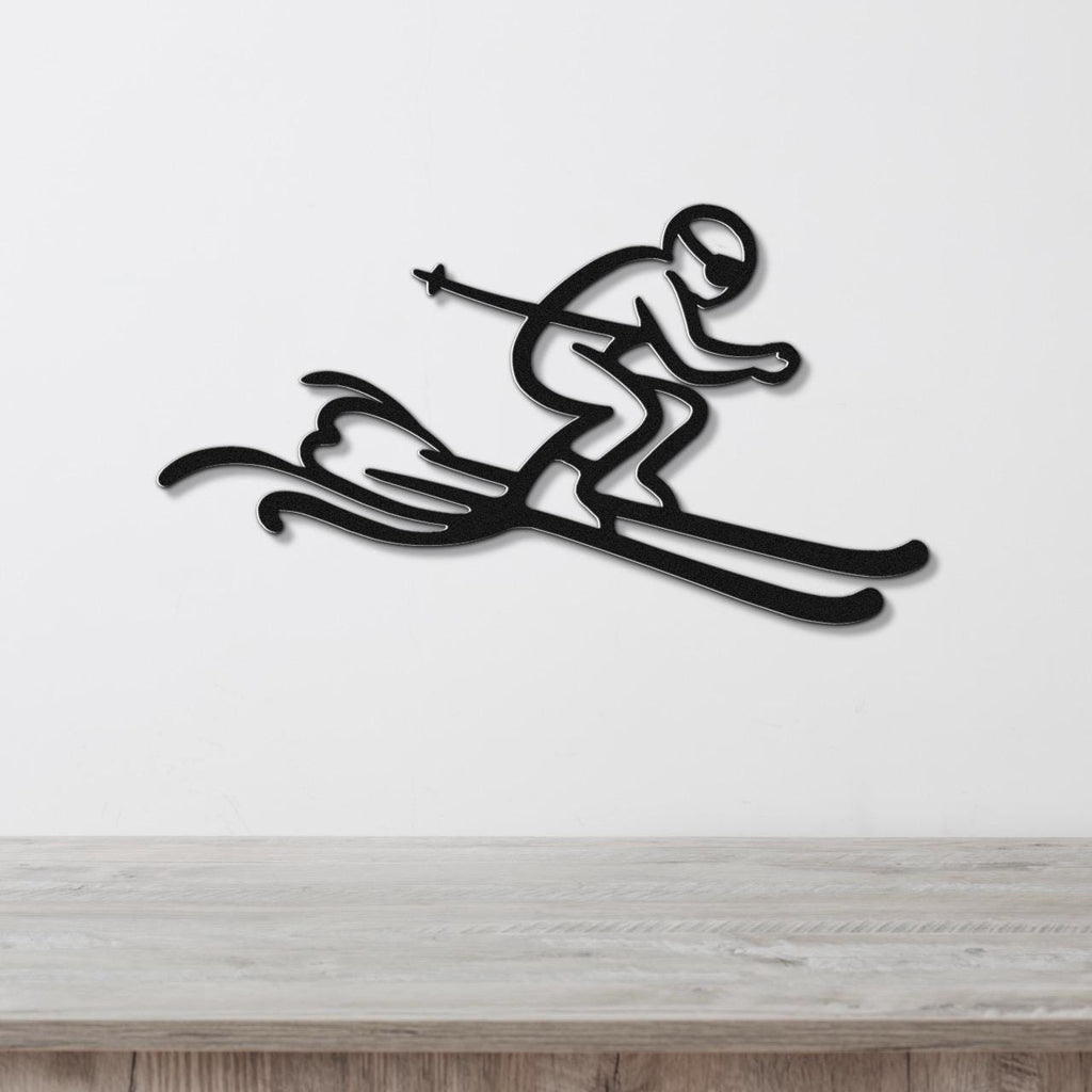 Black metal wall art featuring a minimalist skier silhouette with dynamic motion lines, mounted on a white wall above a wooden surface.