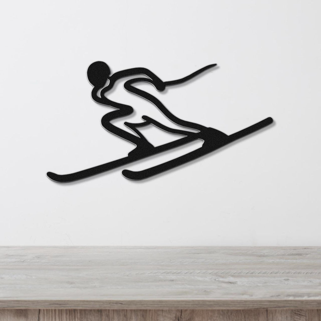 Black metal wall art of a skier silhouette with dynamic motion lines, mounted on a white wall above a light wood surface.