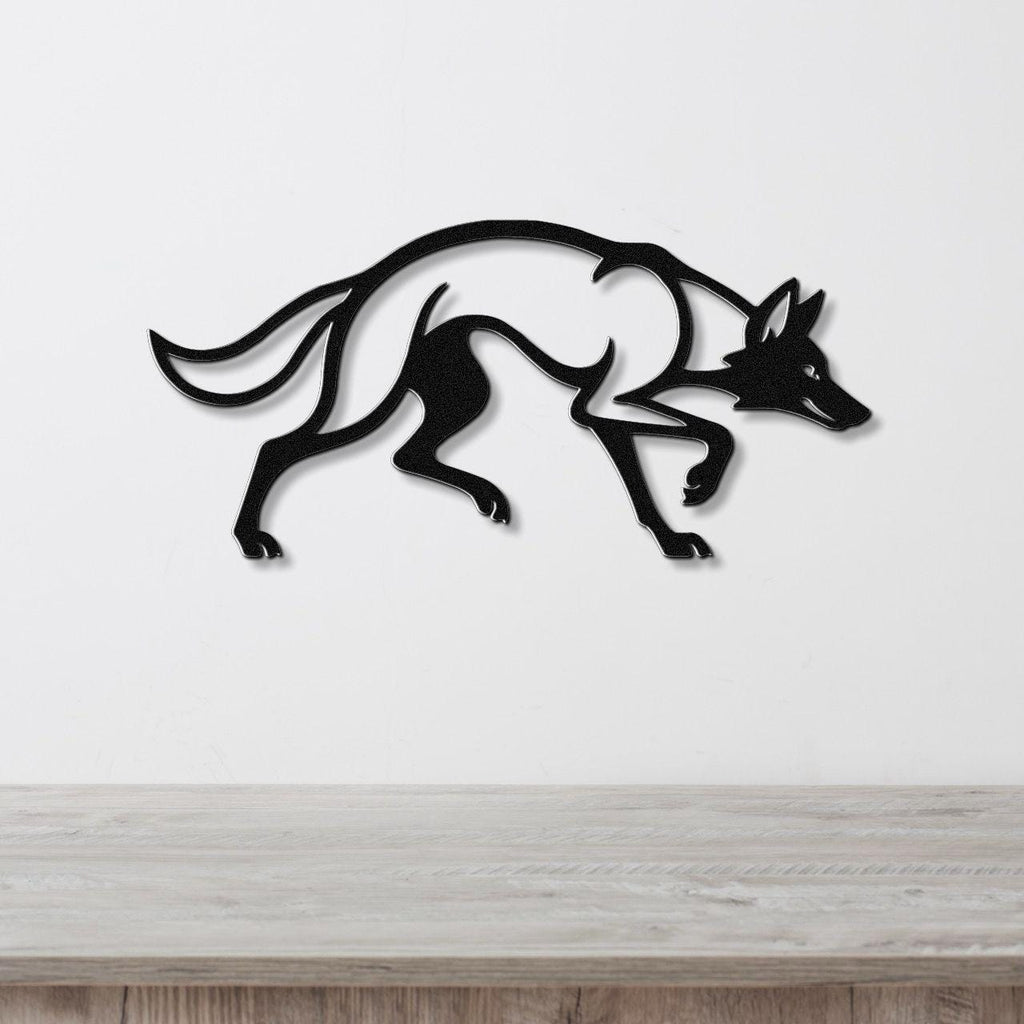 Black metal coyote wall art with motion-line cutouts, mounted on a white wall above a light wood counter.