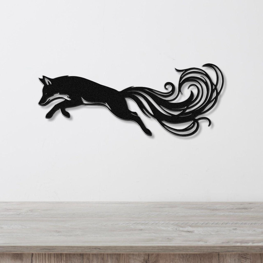 Black metal fox wall art with flowing tail cutouts, mounted on a white wall above a light wood counter.
