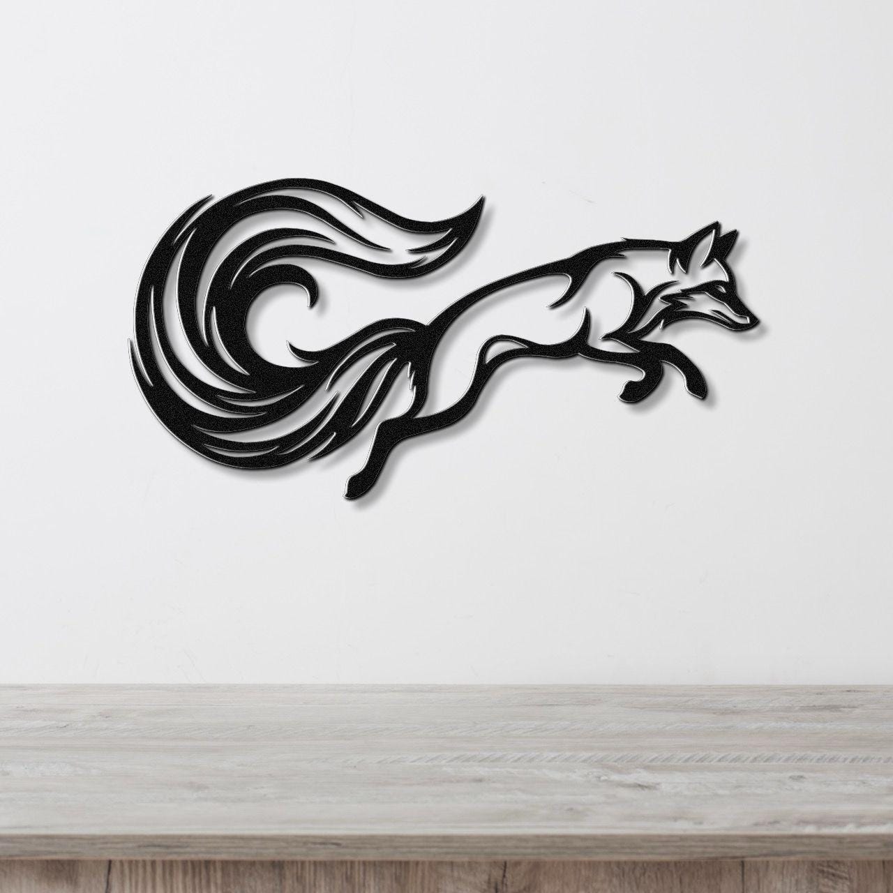 Black metal fox wall art with flowing tail cutouts, mounted on a white wall above a light wood counter.
