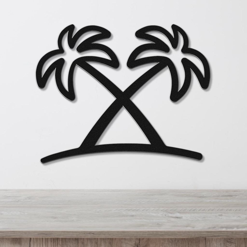 Black metal wall art featuring a silhouette of two crossed palm trees with leafy fronds, mounted on a white wall above a light wood surface.