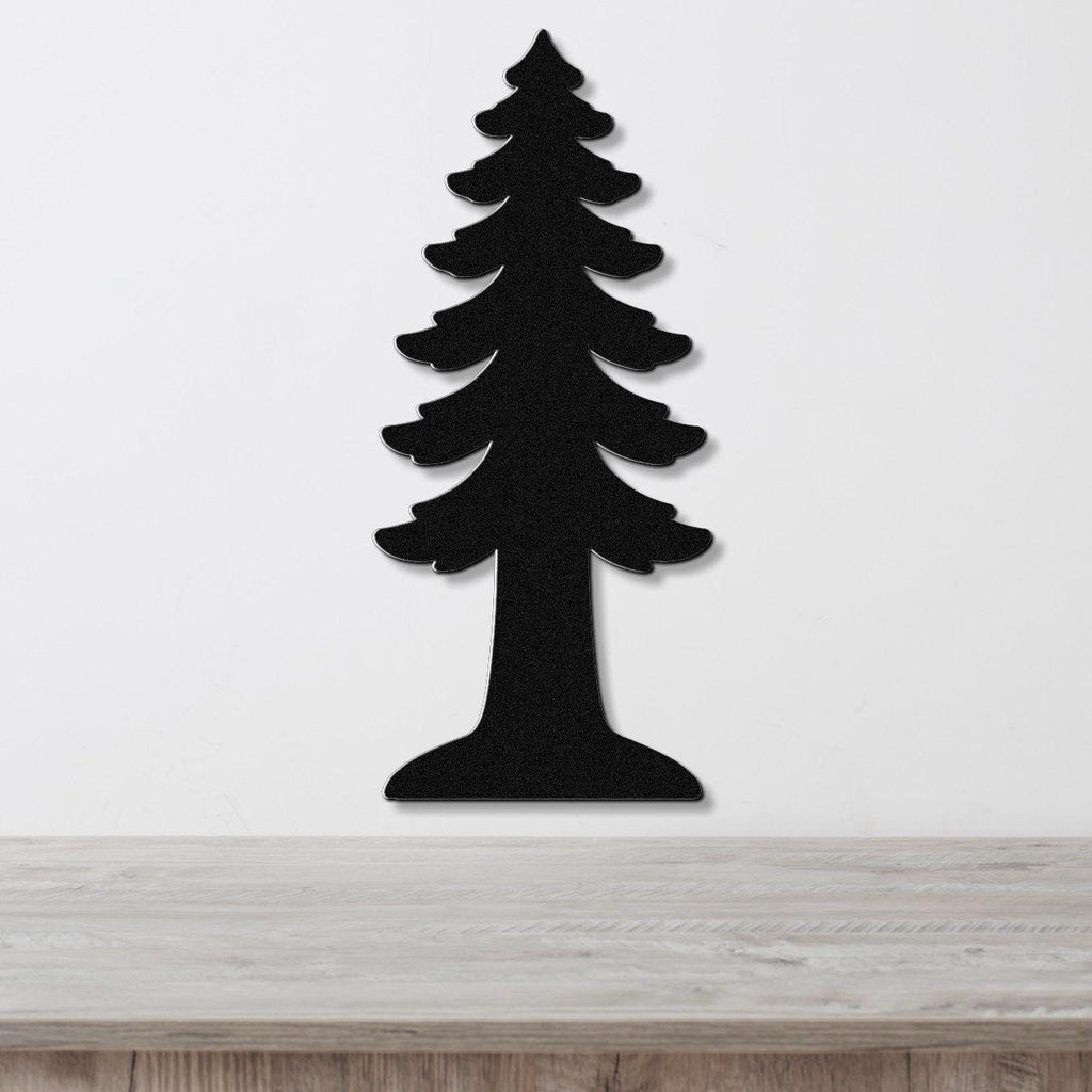 Black metal wall art in the silhouette of a redwood tree, mounted on a white wall above a light wood surface.