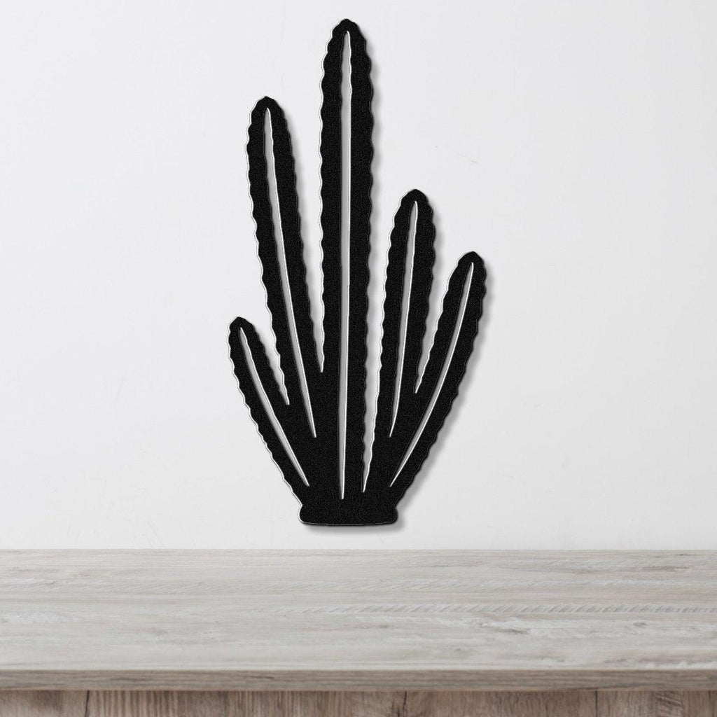 Black metal wall art cutout of an organ pipe cactus with multiple vertical arms, mounted on a white wall above a light wood surface.