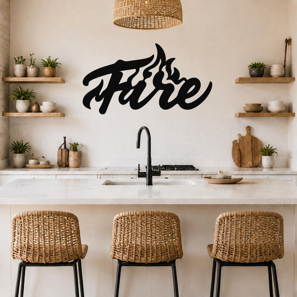 Black metal wall art with a stylized "Fire" design featuring flame-like cutouts, mounted on a kitchen wall above a counter.