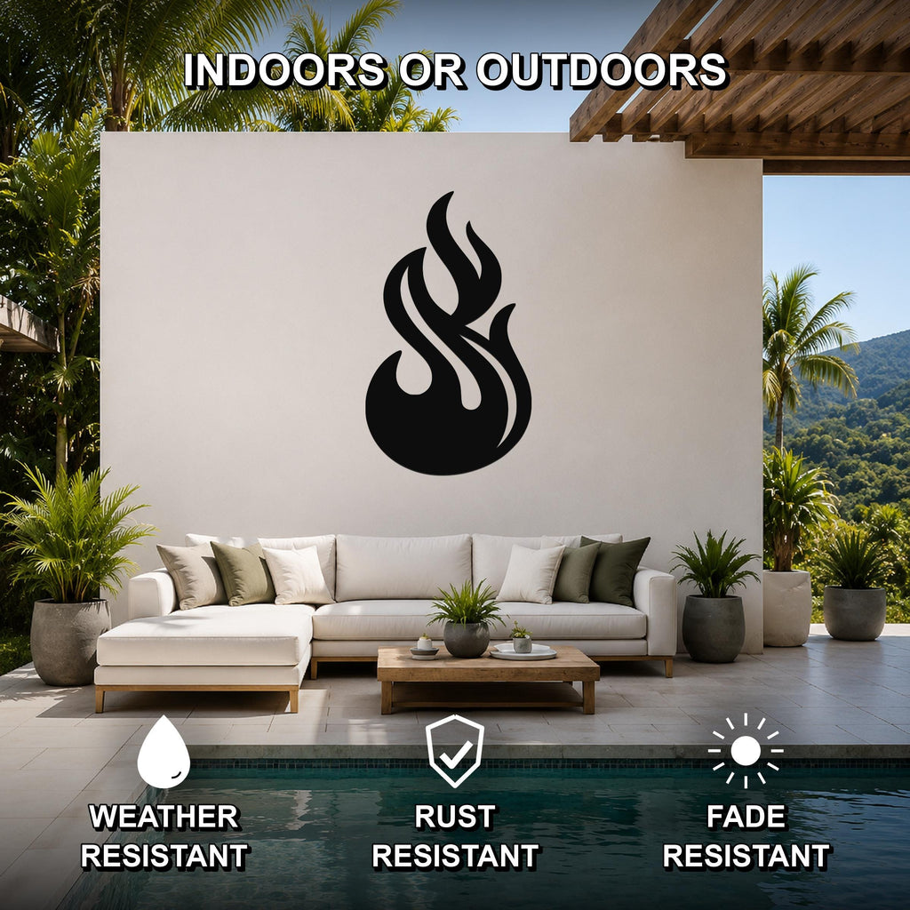 Black metal flame wall art with fluid motion cutouts, mounted on a white outdoor wall above a sofa in a patio living area.