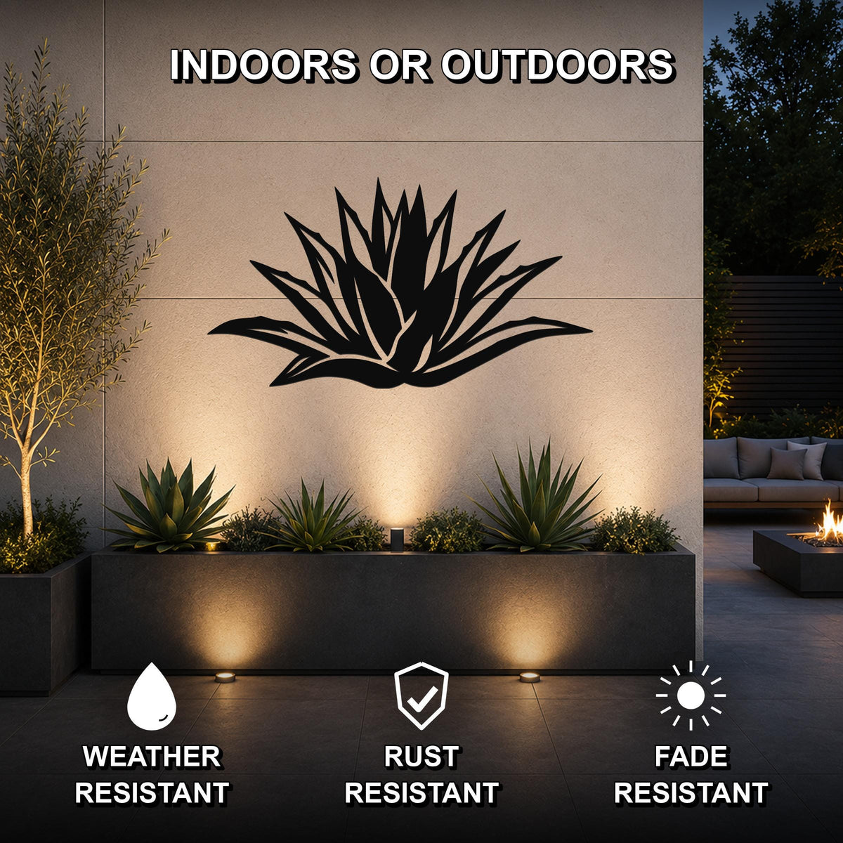Black metal agave wall art with spiky leaf cutouts, mounted on an outdoor wall above a planter in a modern patio setting.