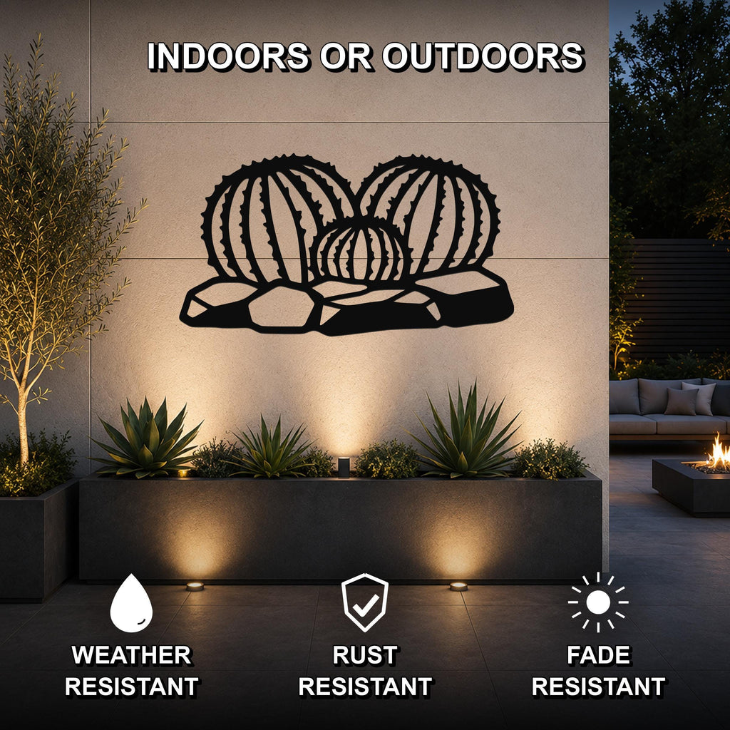 Black metal barrel cactus wall art with ribbed cutouts, mounted on an outdoor wall above a planter in a patio setting.