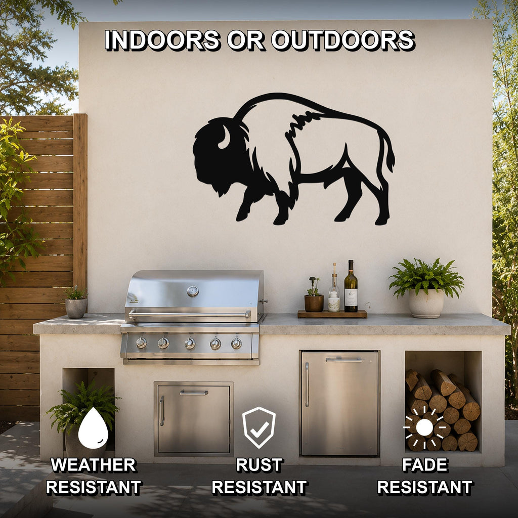 Black metal buffalo wall art silhouette mounted on an outdoor patio wall above a stainless steel grill and counter.