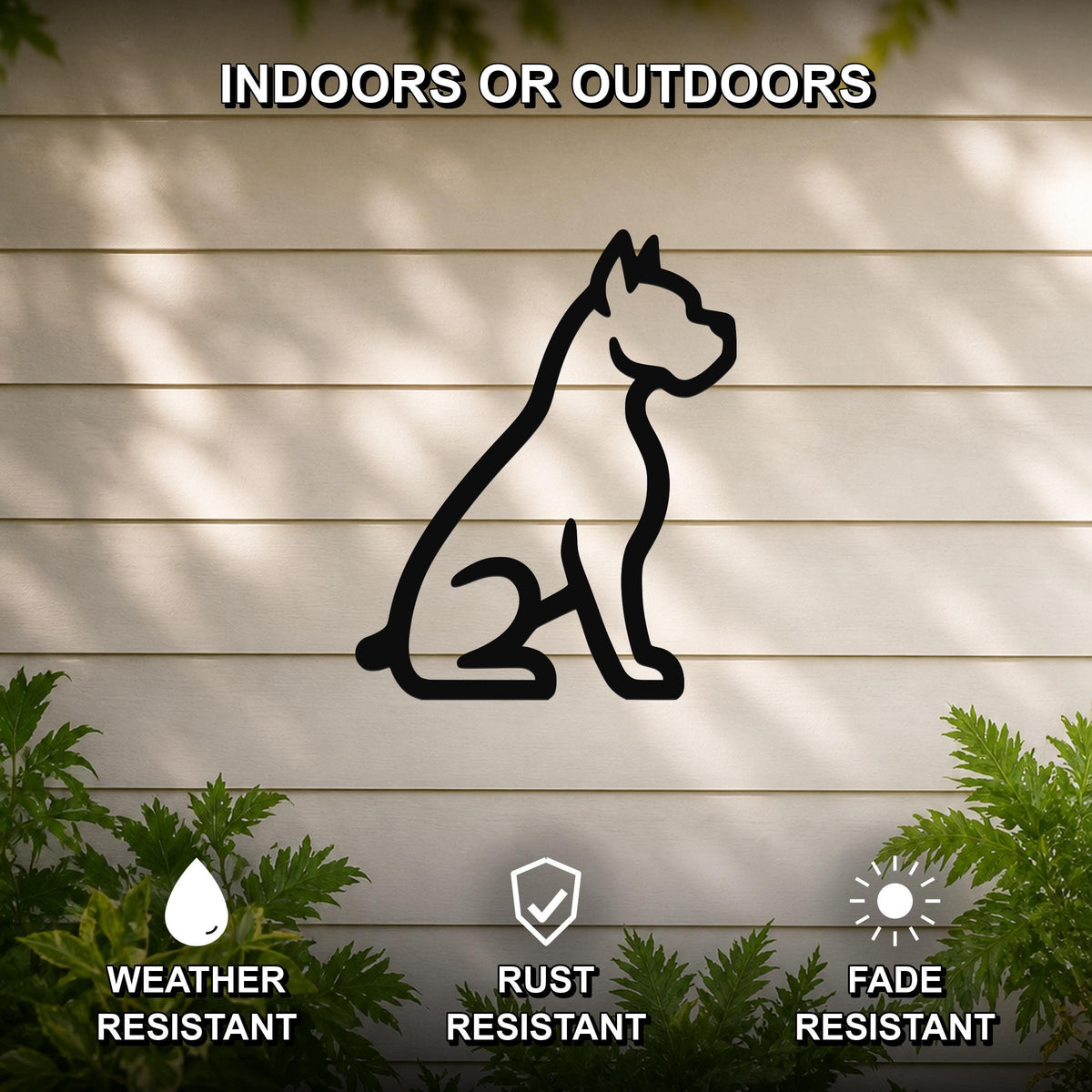 Black metal Boxer dog silhouette wall art mounted on a light-colored outdoor wall, with green plants at the base and text indicating it is weather, rust, and fade resistant.
